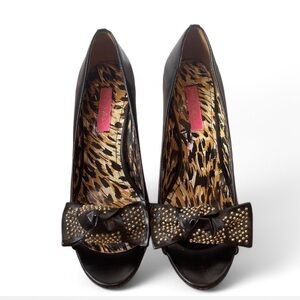 Black peep-toe heels with gold studded bow detailing